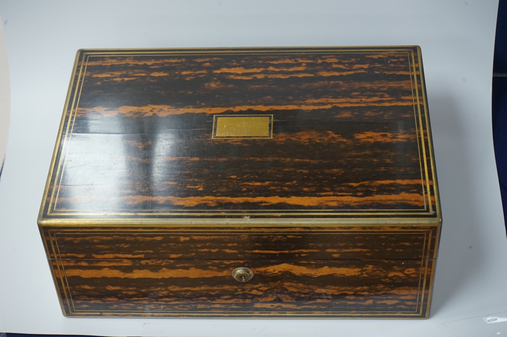 A Victorian brass mounted coromandel wood toilet box by Lund, 57 Cornhill, London, containing eight silver mounted glass toilet jars, six hallmarked for Thomas Johnson I, London, 1865 and three associated? mother of pear